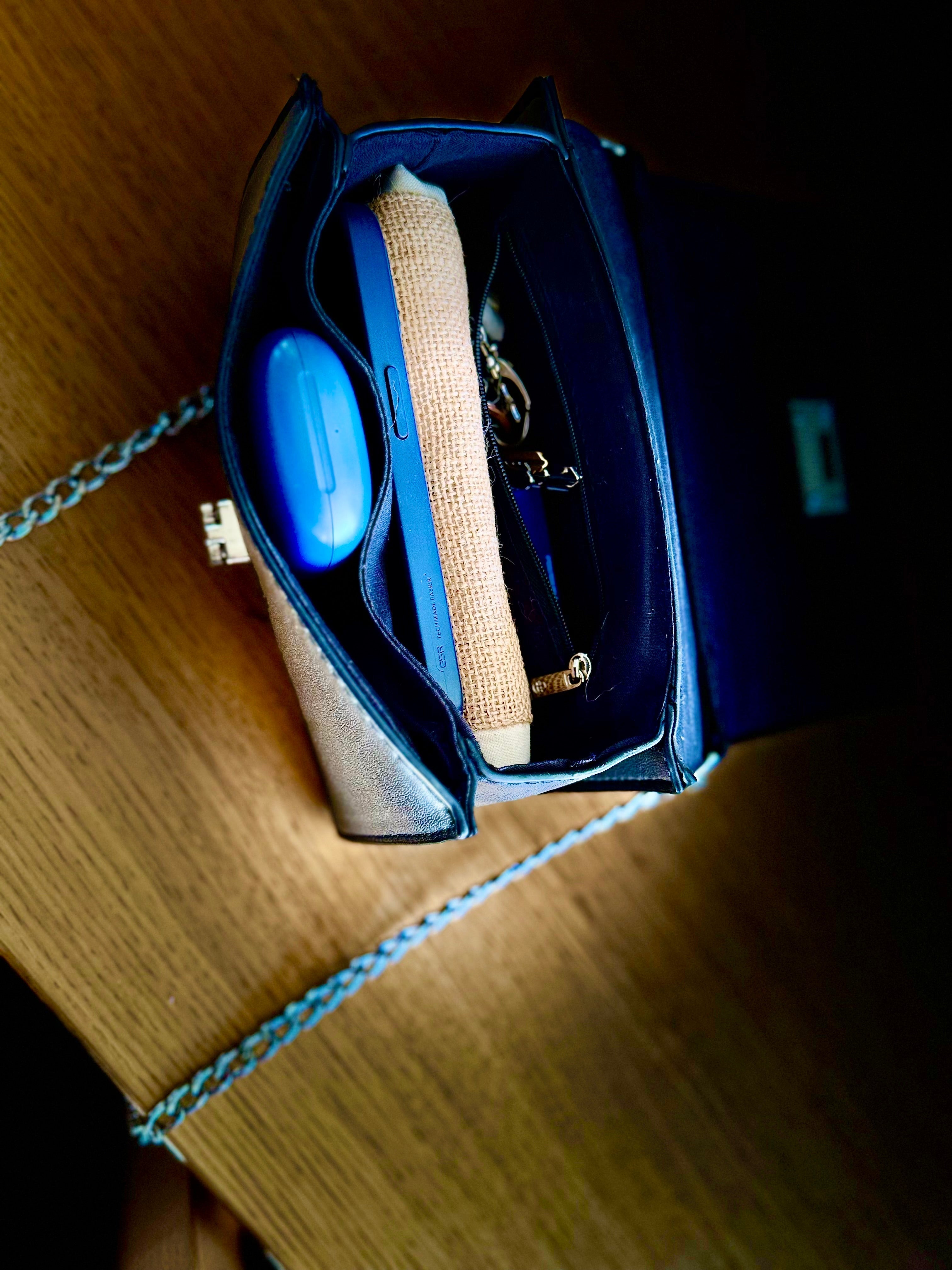 Folded P’tit Affair tote bag neatly placed inside a crossbody bag, showcasing its compact and portable design for everyday convenience.