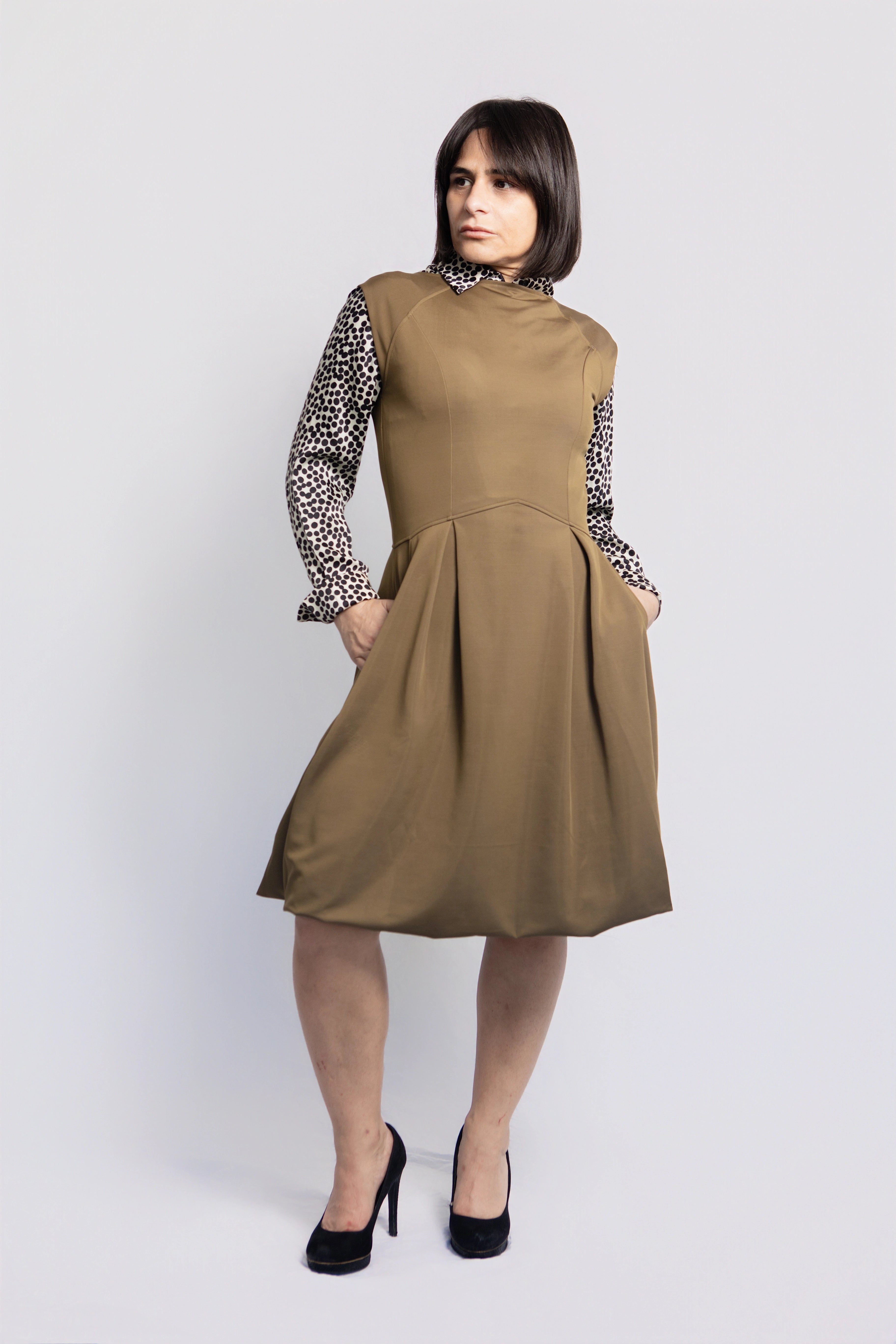 Front view of petite olive green midi dress with pockets, styled over a patterned blouse, tailored fit for women under 5'3, sustainable fashion made in Portugal