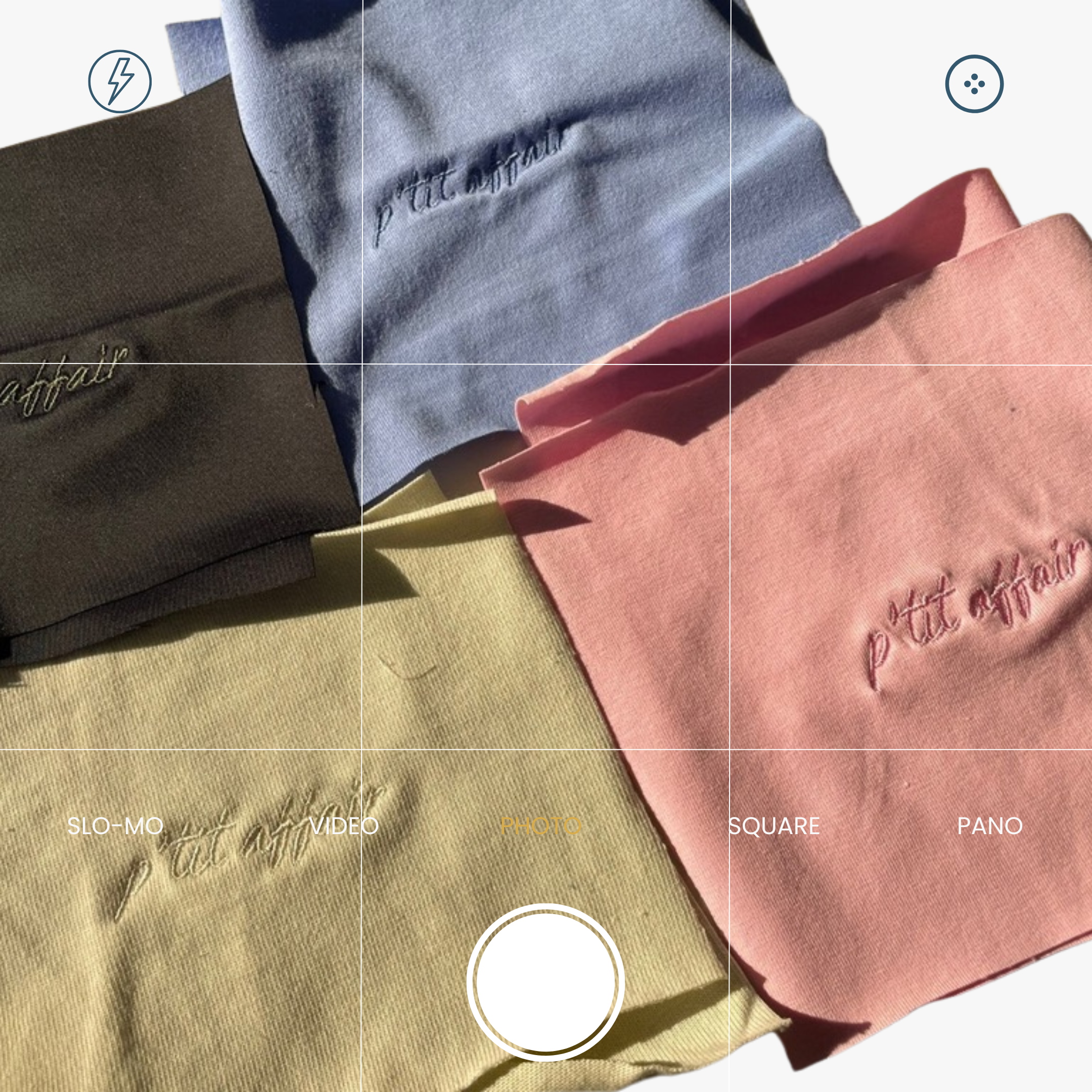 Close-up of an embroidered logo on fabric, showcasing the fine stitching and craftsmanship. Made in Portugal, this embroidery represents quality, durability, and timeless fashion.
