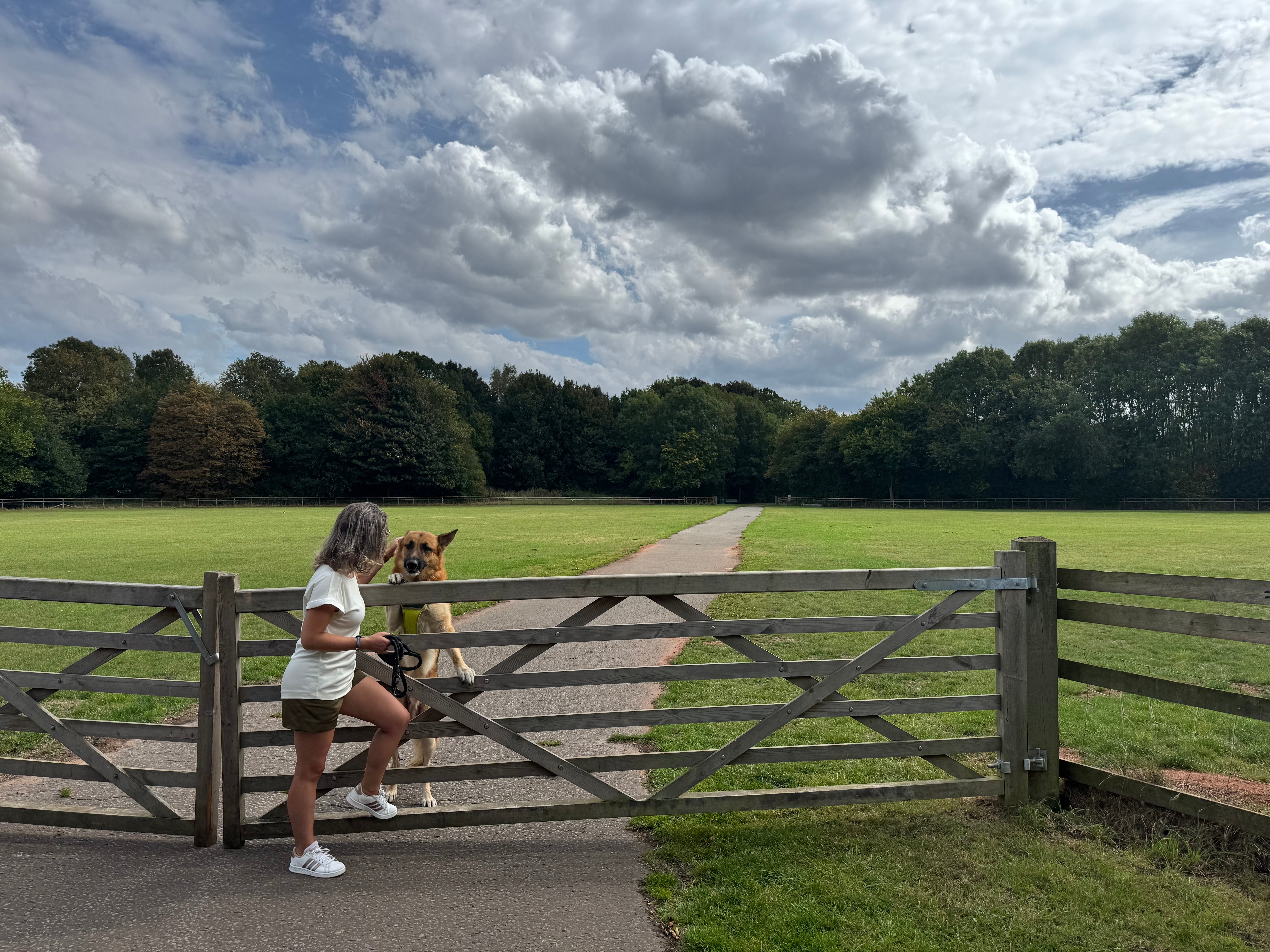 Founder Susana Dias wearing P’tit Affair’s Mariana Tailored Shorts with her German Shepherd, standing by a countryside gate. Capsule wardrobe designed for petite women 5'3" and under.